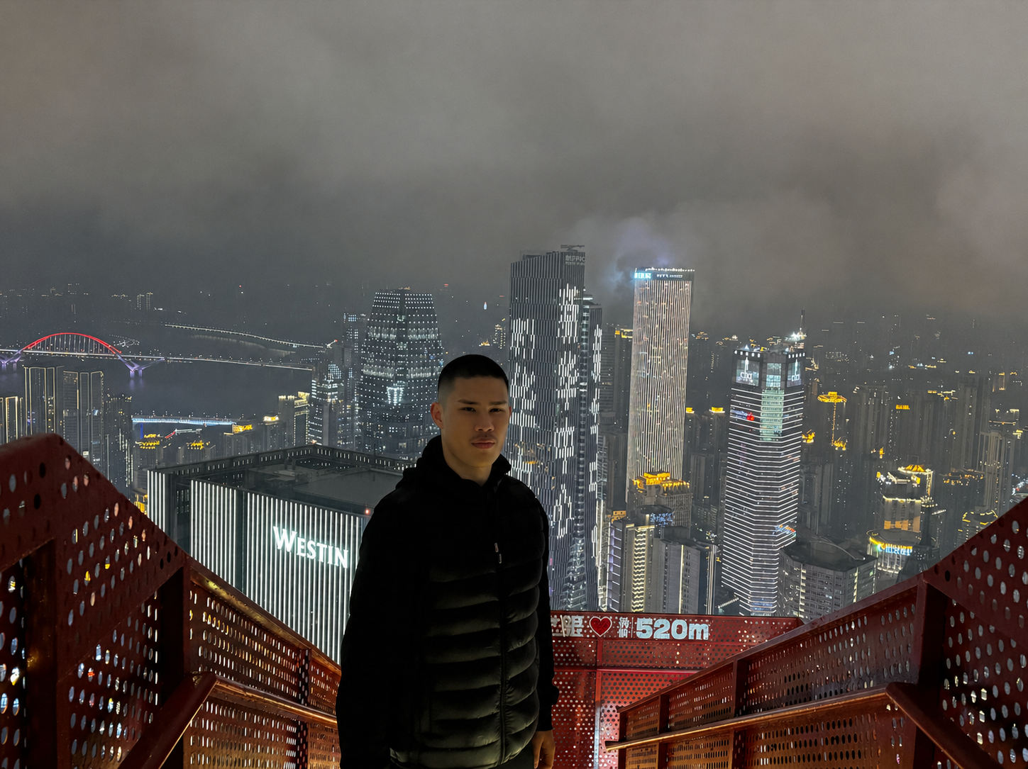 Michael Brown on a viewing platform overlooking the Chongqing skyline at night